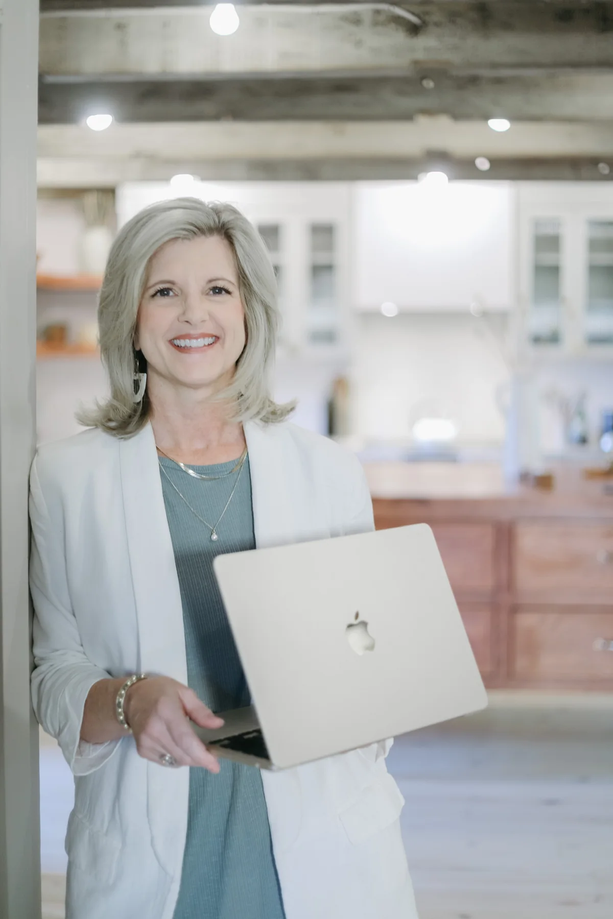 Jennifer Davenport holding a laptop for an online coaching session
